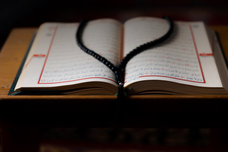 The Holy Quran on the lectern and praying beads. Islamic photo. Selective focus. Ramadan concept.