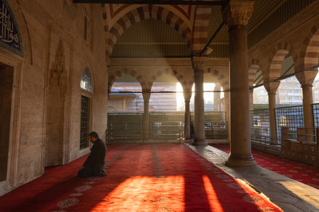 Islamic photo. Muslim man praying in the mosque. Sunrays and haze at sunset. Ramadan or islamic background photo. Istanbul Turkiye - 12.24.2022のeditorial素材