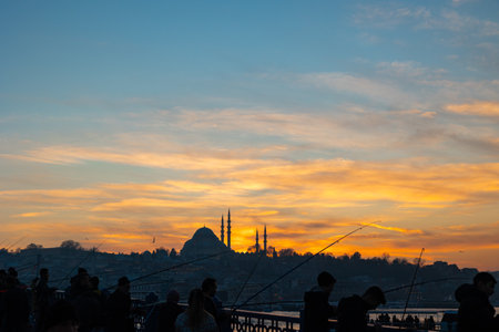 Silhouette of Suleymaniye Mosque and fishermen on the Galata Bridge. Ramadan or islamic concept photo. Travel to Istanbul background photo. Istanbul Turkiye - 12.24.2022のeditorial素材