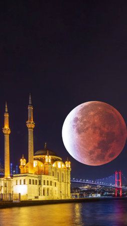 Ortakoy Mosque and lunar eclipse. Islamic or ramadan or laylat al-qadr or kadir gecesi vertical photo with copy space for texts.の写真素材