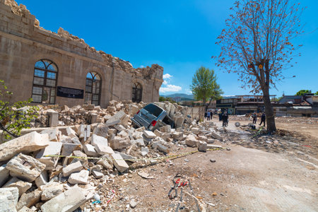 Damaged car from rublle of a historical mosque in Malatya after the 6th fubruary 2023 earthquake. Malatya Turkiye - 4.25.2023のeditorial素材