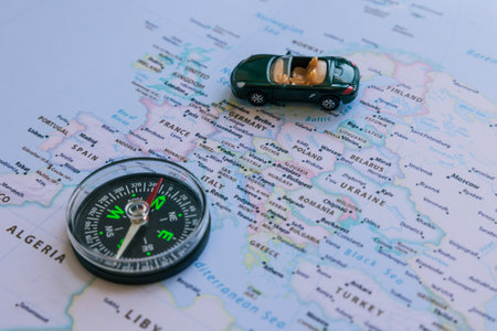 Travel to Europe or European countries concept photo. Compass and a toy car on the Europa map.の写真素材