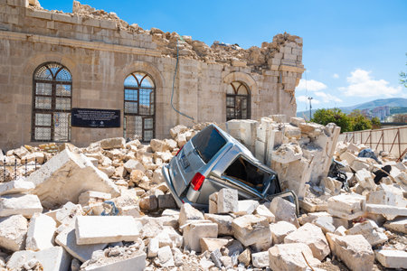 Iconic view of Malatya city after the february 6 earthquakes. a car has been crushed under the rubble of the historical mosque. Malatya Turkiye - 4.25.2023のeditorial素材