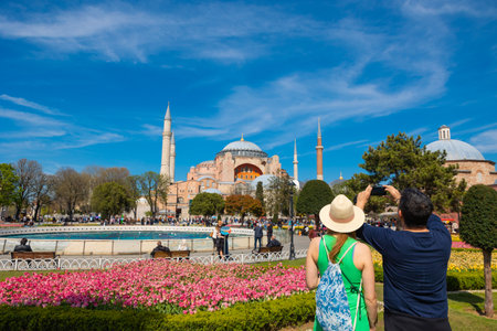 Tourist couple taking photo of Hagia Sophia at daytime in the spring or summer. Istanbul Turkiye - 4.14.2023のeditorial素材