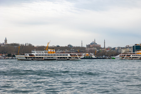 Istanbul view. Ferries and Hagia Sophia with cloudy sky. Istanbul Turkiye - 3.31.2023のeditorial素材