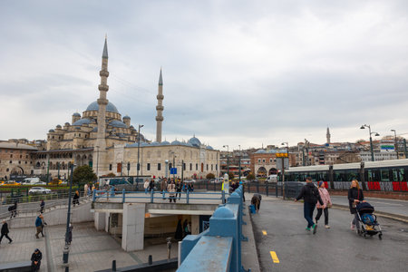 Istanbul view with people, tram and famous Eminonu New Mosque or Yeni Cami. Istanbul Turkiye - 3.31.2023のeditorial素材