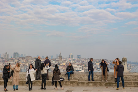 People or tourists taking photos of Istanbul from the garden of Suleymaniye Mosque. Galata Tower and istanbul skyline on the background. Istanbul Turkiye - 12.23.2022のeditorial素材