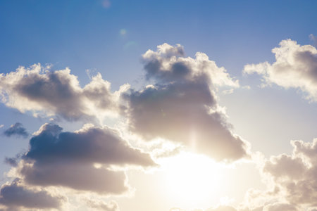 Clouds and sun at sunset. Cloudscape background photo. Religion concept background.