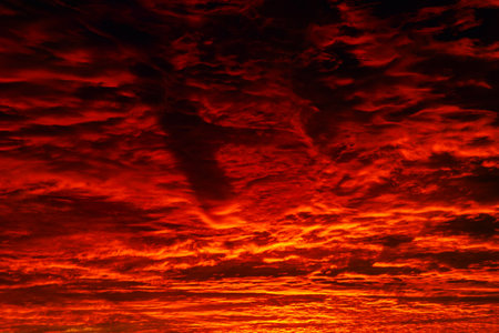 Red and orange clouds at sunrise or sunset. Dramatic sunset or sunrise background photo.