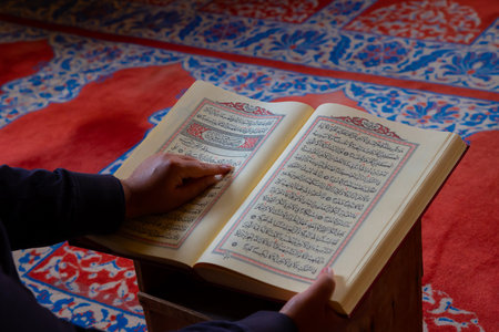 Ramadan or islamic background photo. Muslim man reading the holy Quran in a mosque.の写真素材