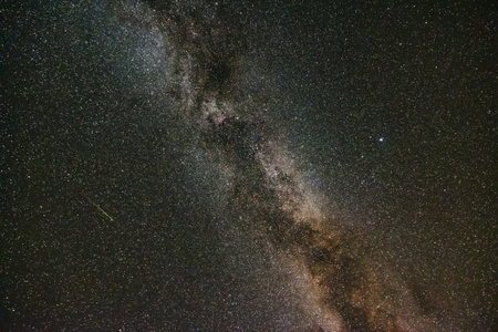 The Milky Way and a little meteor with trail. Space background photo. Perseid meteor shower.
