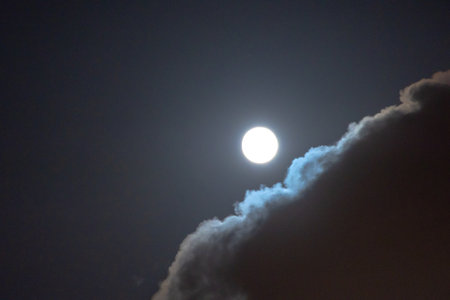 Full moon with clouds. Night sky background photo.の写真素材