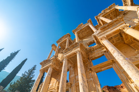 Ephesus in Izmir Turkey. Library of Celsus with trees and clear blue sky. Visit Turkey concept...