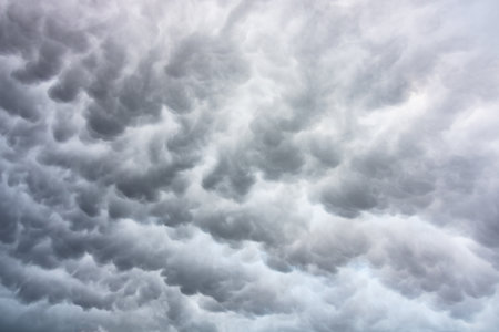 Dramatic mammatus clouds background photo. Dramatic sky backdrop.