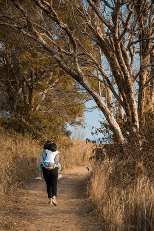 Mother pick up her child on traveling の写真素材