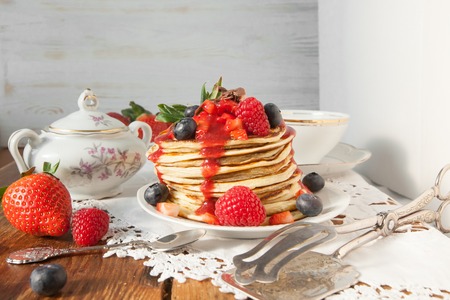 Strawberry chocolate pancakes on a vintage tableの写真素材
