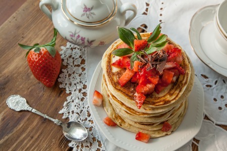 Strawberry chocolate pancakes on a vintage table