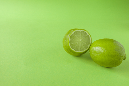Perfect Fresh Green lime fruit Isolated on green Background  Full Depth of Fieldの写真素材
