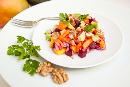 Avocado, mango, beetroot and walnut salad on white backgroundの写真素材
