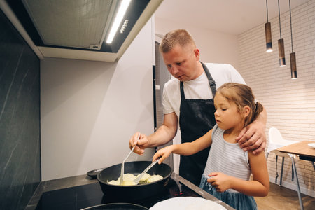 Cooking Together An Inspiring Dad and Daughter Bonding Moment in the Kitchen Fun. Happy family...