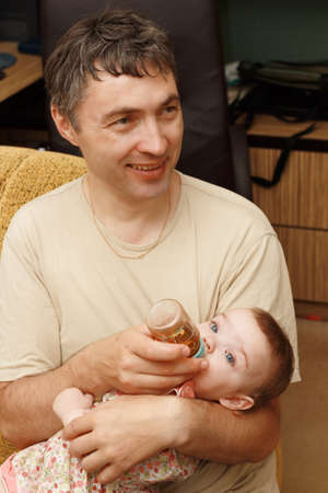 The man feeds the baby の写真素材