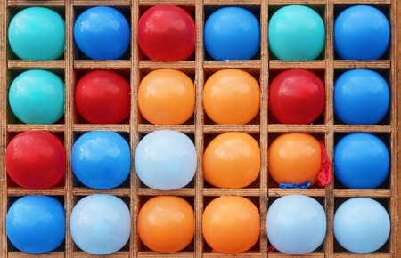 Color balloons in wooden cells.の写真素材