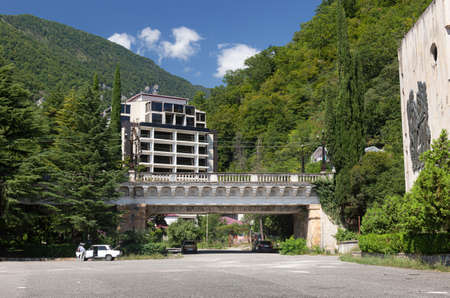 Old railroad bridge and modern hotel. View from central street of Gagra Town, July of 2018, Abkhasia.のeditorial素材