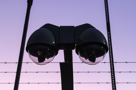 modern surveillance camera and barbwireの写真素材