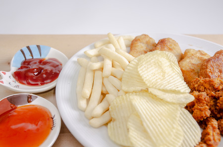 Crisps Fried food in white plate The waistline is on the table.Healthy eating and active lifestyle concept.Do not focus on objects.の写真素材