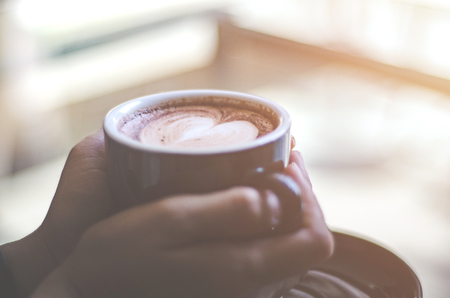 Coffee cup on the table in the cafe.In a cafe with a cup of coffee.Do not focus on objects.の写真素材