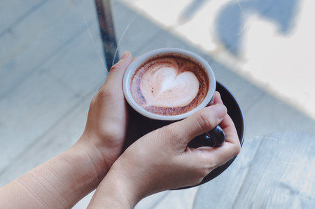 Coffee cup on the table in the cafe.In a cafe with a cup of coffee.Do not focus on objects.の写真素材