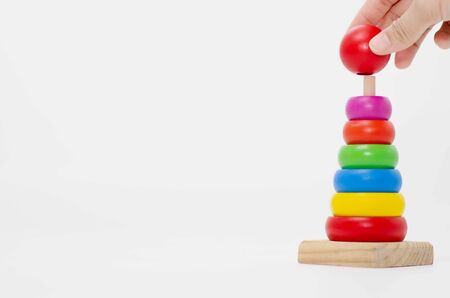 Wooden toys are red, green, yellow, and blue. Many numbers arranged beautifully.Red round wood Captured by hand.isolated a white background.Copy space.の写真素材