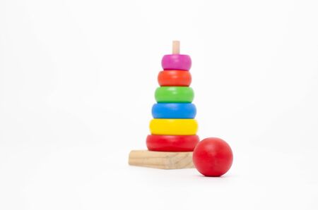 Wooden toys are red, green, yellow, and blue. Many numbers arranged beautifully. Red round wood Captured by hand.isolated a white background. Copy space.の写真素材