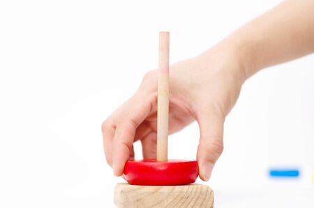 Wooden toys are red, green, yellow, and blue. Many numbers arranged beautifully.Red round wood Captured by hand.isolated a white background.Copy space.の写真素材