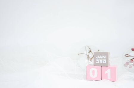 Pink wooden blocks number 0 and 1 placed on a white background.の写真素材