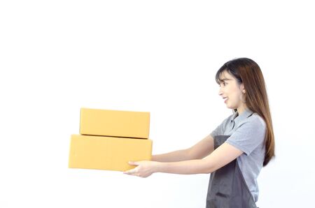 Asian women in a purple shirt, blue pants, she smiled and held several brown boxes at the same time isolated white background.Women send parcels.Do not focus on objects.の写真素材
