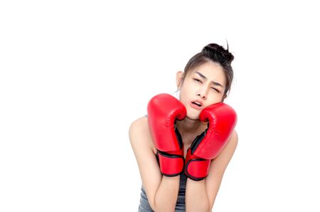 Asian Woman Wearing Red Boxing Gloves.The girl put her hands on her ears.Women are tired.の写真素材