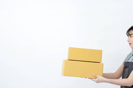 Beautiful asian woman The yellow dress is smiling Hold a gift box.Do not focus on objects.solated on...