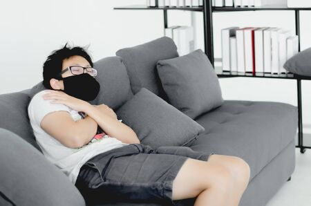 Asian men wearing black masks.A man wearing glasses.The man in the white room.の写真素材