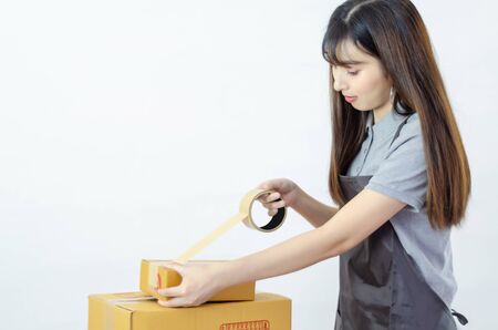 Beautiful Asian woman wearing a gray shirt With an apron, she was smiling.の写真素材
