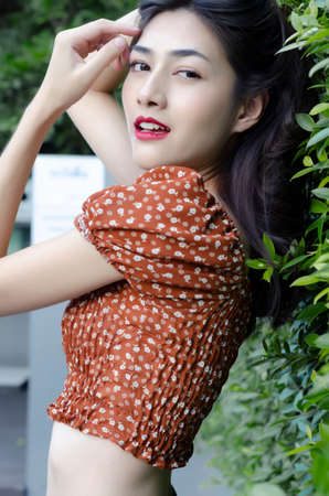 Beautiful asian women In a brown shirt, relaxing in the pool.の写真素材