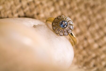 Beautiful  gold ring with rocks and hemp.