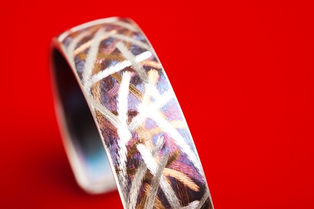Silver jewelery over red background