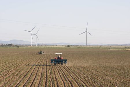 Farmer with tractor and windmillのeditorial素材