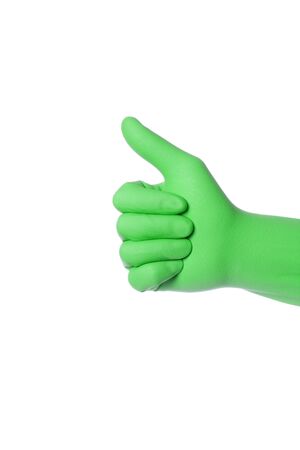 Hand wearing green rubber glove shows thumb up sign, isolated over white の写真素材