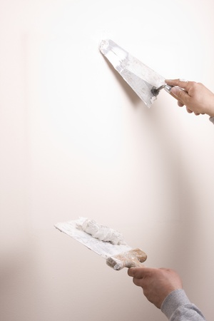 Putty Knife with Paste to Repair Wall Damageの写真素材