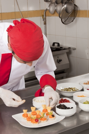 	chef garnishing canapesの写真素材