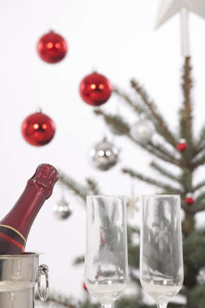 Christmas glasses of champagne, Christmas tree and giftsの写真素材