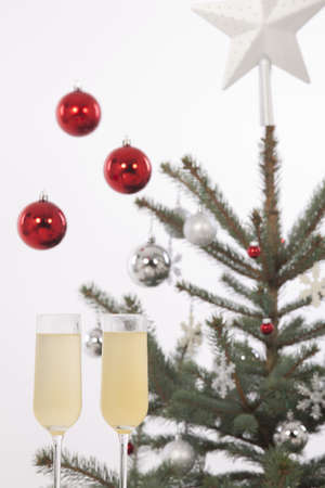 Christmas glasses of champagne, Christmas tree and giftsの写真素材