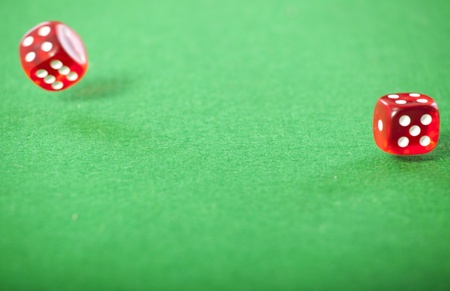 Rolling red dice on a casino table の写真素材